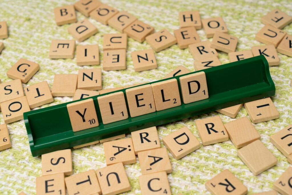 a scrabble board with the word yield written on it